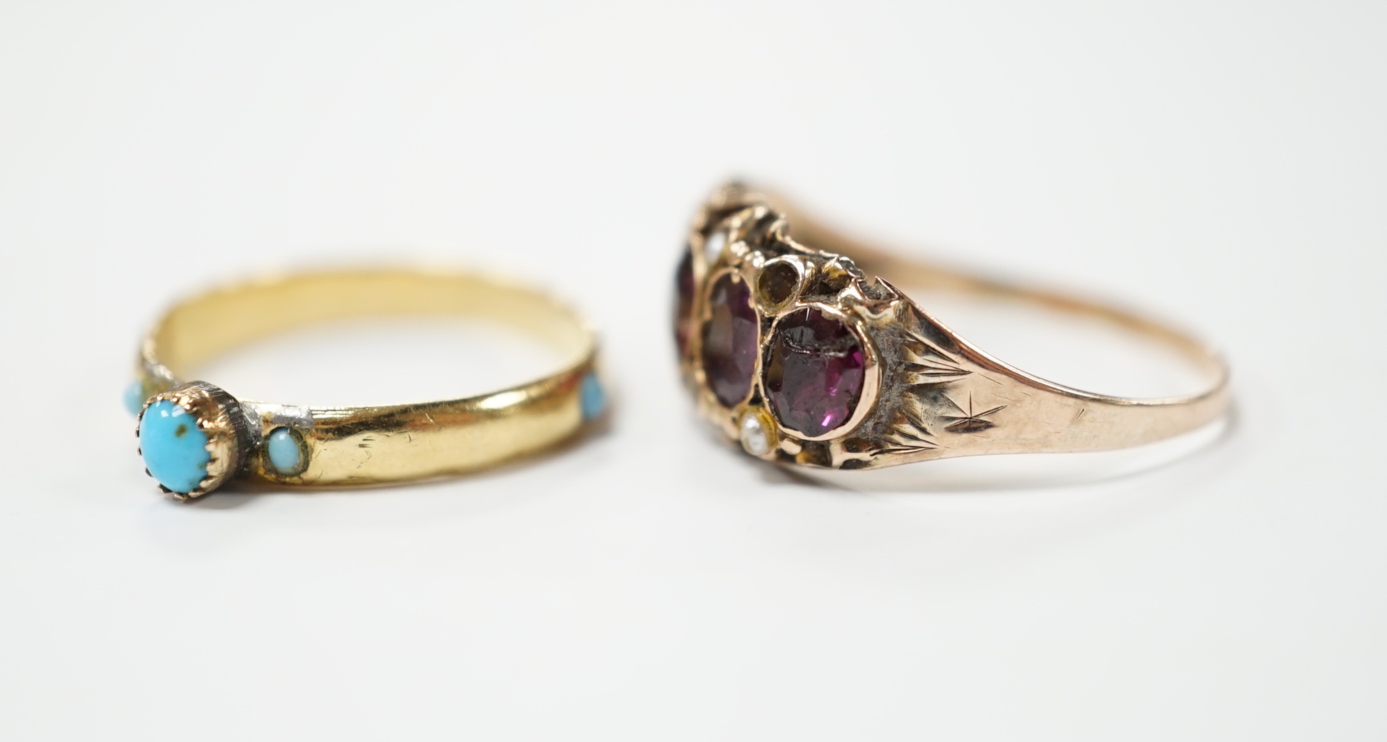 A Victorian garnet and seed pearl dress ring, size O, and a turquoise set yellow dress ring, size K